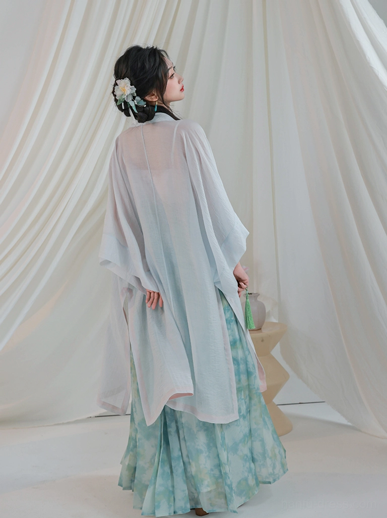 Back view of flowing Song Dynasty inspired lotus hanfu with lightweight sheer cardigan and long cyan pleated skirt