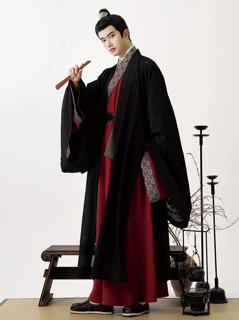 Side three-quarter view of a man in a complete Jingchuan-inspired Song Dynasty hanfu outfit with layered robes, flowing sleeves, matching trim, and traditional styling