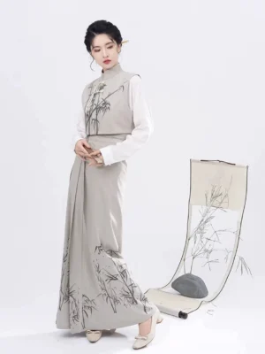 Full-body three-quarter view of a modern Song Dynasty Hanfu three-piece set with off-white top, bamboo print Majia vest, light grey wrap skirt, and elegant oriental styling