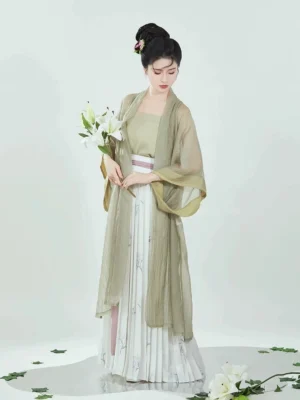 Full-body front view of a woman wearing a sage green Song Dynasty modern Hanfu Bubble Tea three-piece outfit with sheer overcoat, camisole, bamboo print pleated skirt, and pink waist sash