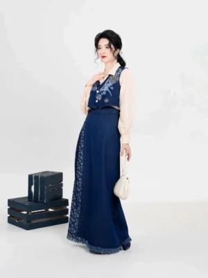 Side view of modern Song Dynasty Hanfu outfit with embroidered navy majia vest and long raw-hem denim-style wrap skirt