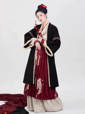 Full-body front view of a Song Dynasty modern Chinese New Year hanfu set with black outer robe, red pleated floral skirt, embroidered inner top, beige trim, and plum blossom hair accessory