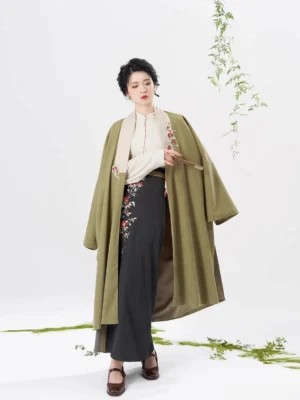 Full body front view of olive green Song Dynasty modern hanfu set with long coat ivory top and dark grey embroidered spiral skirt