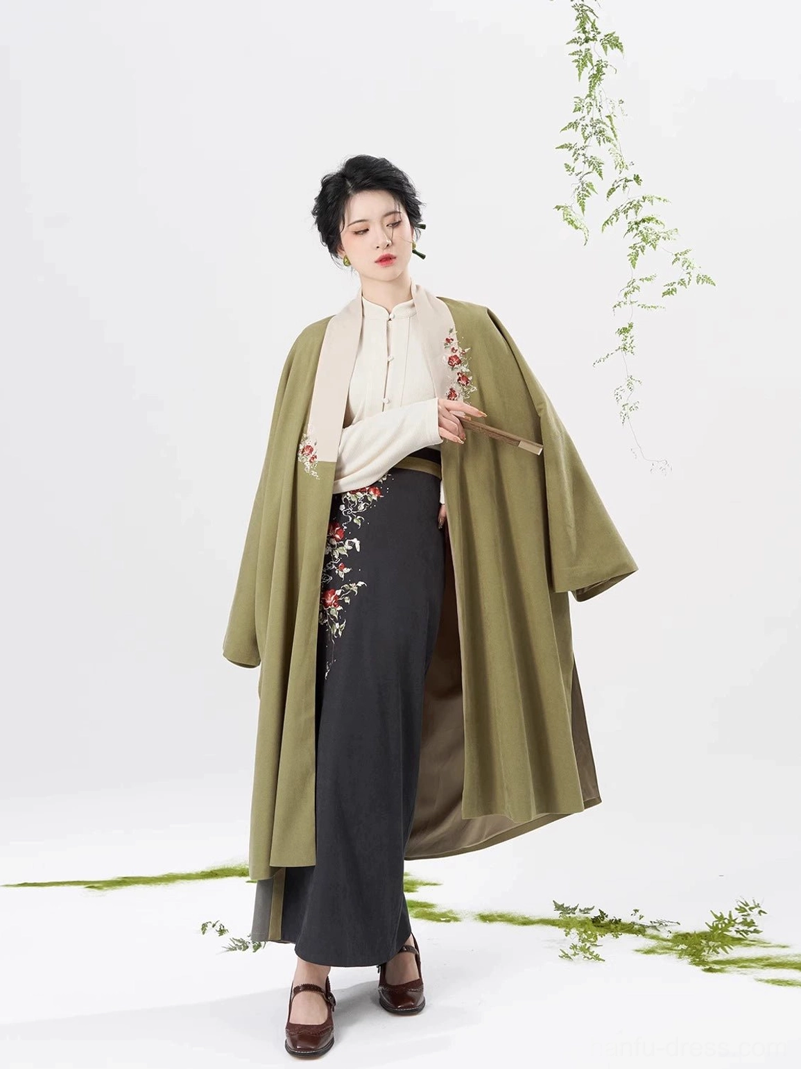 Full body front view of olive green Song Dynasty modern hanfu set with long coat ivory top and dark grey embroidered spiral skirt