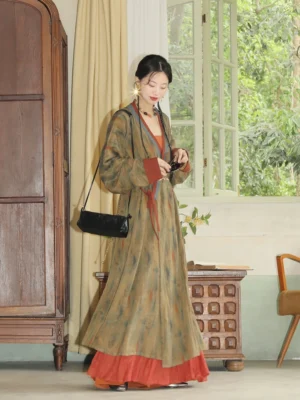 Full-body side view of a woman wearing an olive green Song Dynasty modern Hanfu straight robe with rust red and blue contrast trims and a layered flowing skirt in a vintage interior