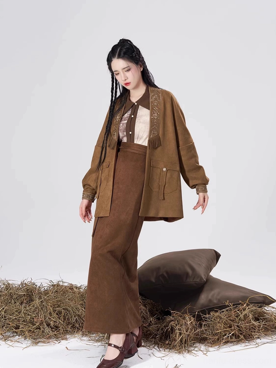 Side view of a woman wearing a brown Song Dynasty modern Hanfu three-piece set with a long sleeve top, flowing wrap skirt, and open coat