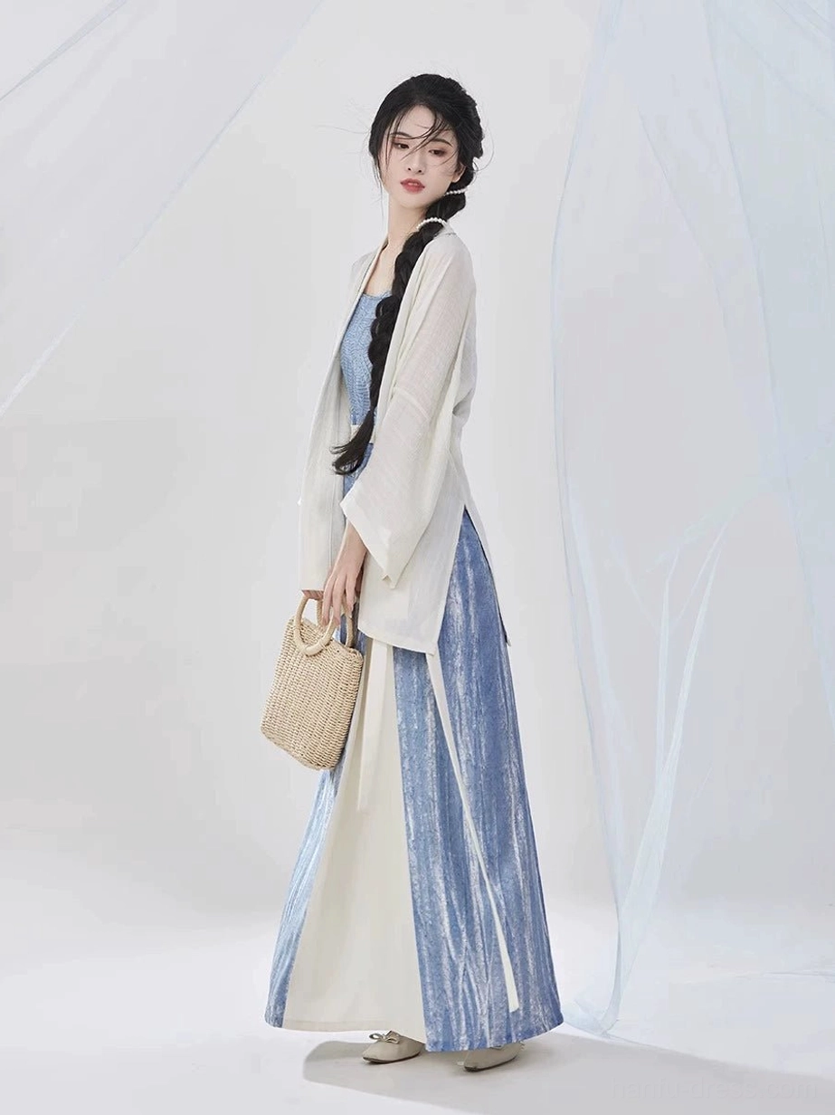 Side view of a Song Dynasty modern Hanfu three-piece outfit showing the relaxed ivory sleeve fit, flowing floor-length skirt, and two-tone blue side panel design