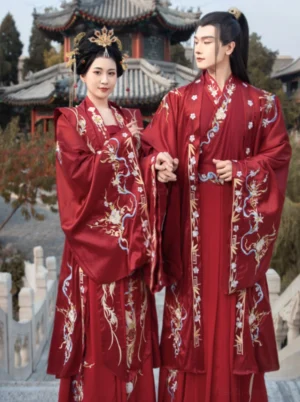Song Dynasty inspired crimson phoenix bridal hanfu worn by couple in a traditional Chinese garden with pavilion