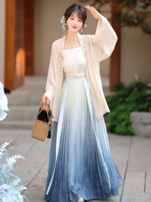 Front three-quarter view of a three-piece Song Dynasty Qiyao Ruqun Hanfu with embroidered cream beizi coat, white camisole, and blue ombre pleated skirt in a traditional Chinese courtyard