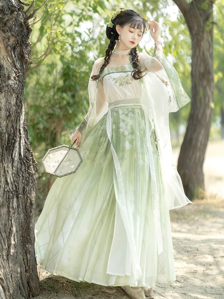 Side view of flowing Song Dynasty Qiyao Ruqun Hanfu with full pleated skirt and sheer outer robe on a woodland path