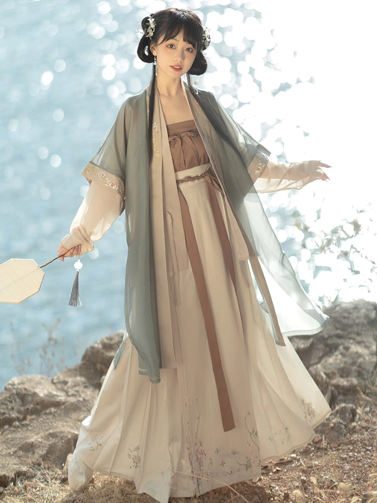 Song Dynasty Hanfu layered outfit with sage green sheer beizi, beige sleeves, brown camisole, floral embroidered skirt and silk fan