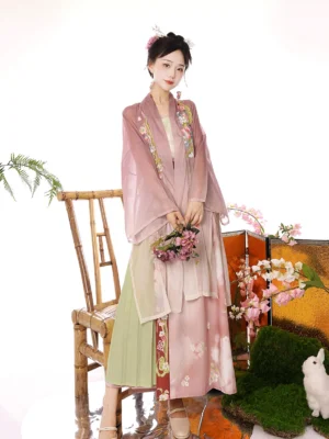 Song Dynasty style qiyao ruqun hanfu set three quarter view showing sheer pink floral beizi, green skirt and reddish brown waistband