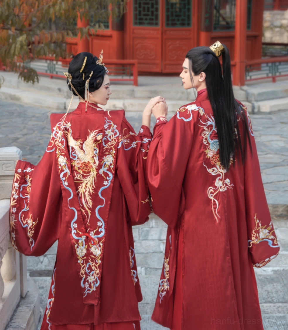 Back view of Song Dynasty style red wedding hanfu couple with embroidered phoenix cloud patterns and wide sleeves