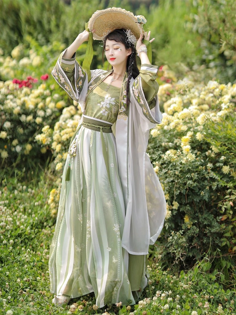 Front view of a woman in elegant green and ivory Song Dynasty style hanfu with floral straw hat, embroidered collar, striped skirt, and layered beizi coats