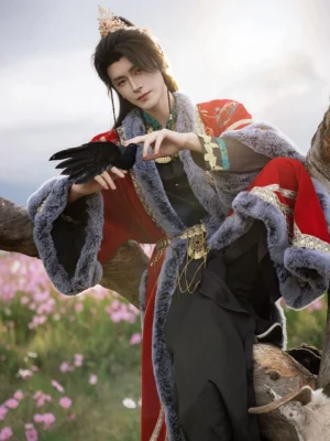 Male model wearing a red Song Dynasty inspired swordsman hanfu coat with grey faux fur trim, gold shoulder embroidery, and layered waist accessories outdoors