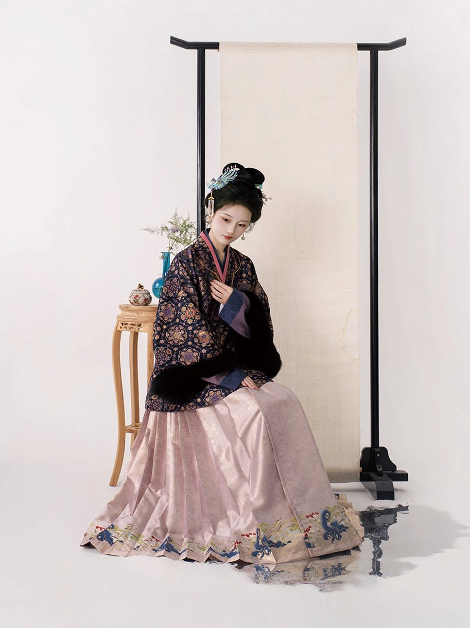 Side seated view of dusty pink pleated mamianqun horse face skirt with embroidered hem from Song Dynasty inspired winter Hanfu outfit
