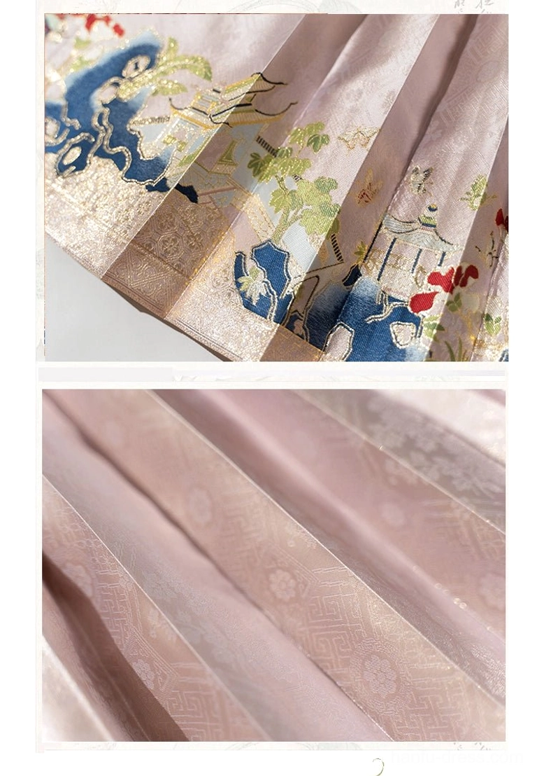 Close-up of pleated dusty pink mamianqun horse face skirt with traditional auspicious animal embroidery along the hem