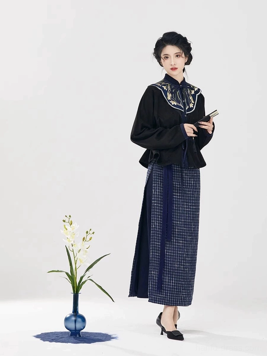 Modern Song Dynasty hanfu outfit with matching embroidered black top and navy micro plaid wrap skirt shown from the front