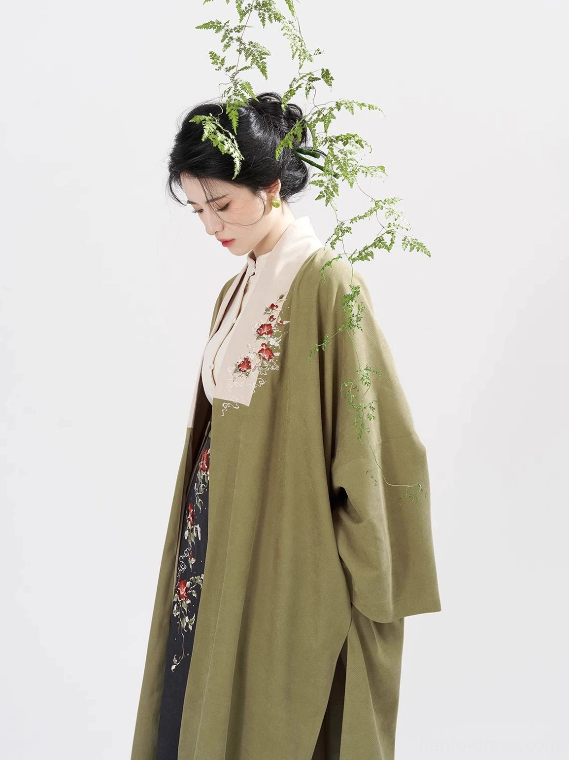 Side view detail of Song style olive green hanfu coat and ivory inner top with floral embroidered collar