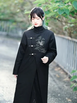 Front view of a black Songhe embroidered modern Hanfu tweed long coat with stand collar, metal toggle closures, and pine crane embroidery