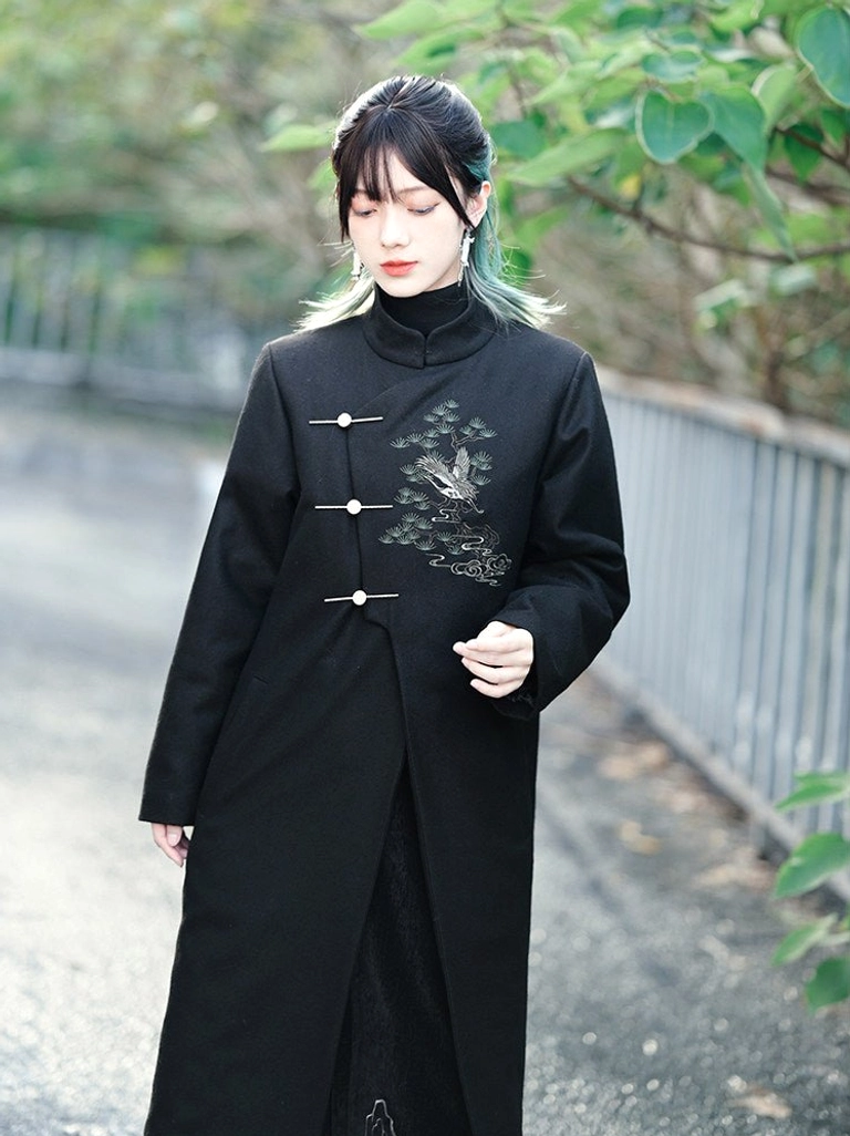 Front view of a black Songhe embroidered modern Hanfu tweed long coat with stand collar, metal toggle closures, and pine crane embroidery