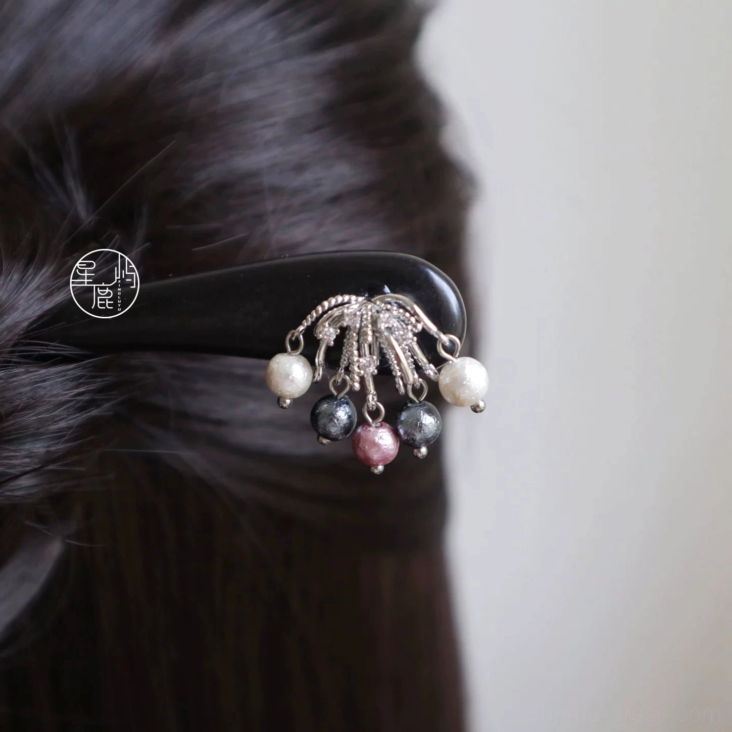 Traditional Chinese wooden hair stick with silver-tone filigree ornament and white dark gray burgundy bead tassels worn in a dark brown Hanfu hairstyle