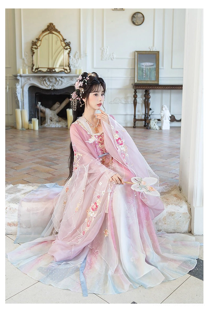 Spring Banquet Tang Dynasty Hanfu heziqun seated indoor view highlighting the floor-length pink blue gradient skirt, floral embroidery, and wide sleeves