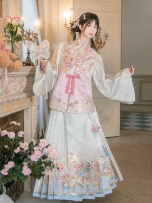 Spring Blossoms Ming Dynasty Hanfu outfit with blush pink floral vest, wide pipa sleeves, and ivory horse-face skirt in a vintage interior