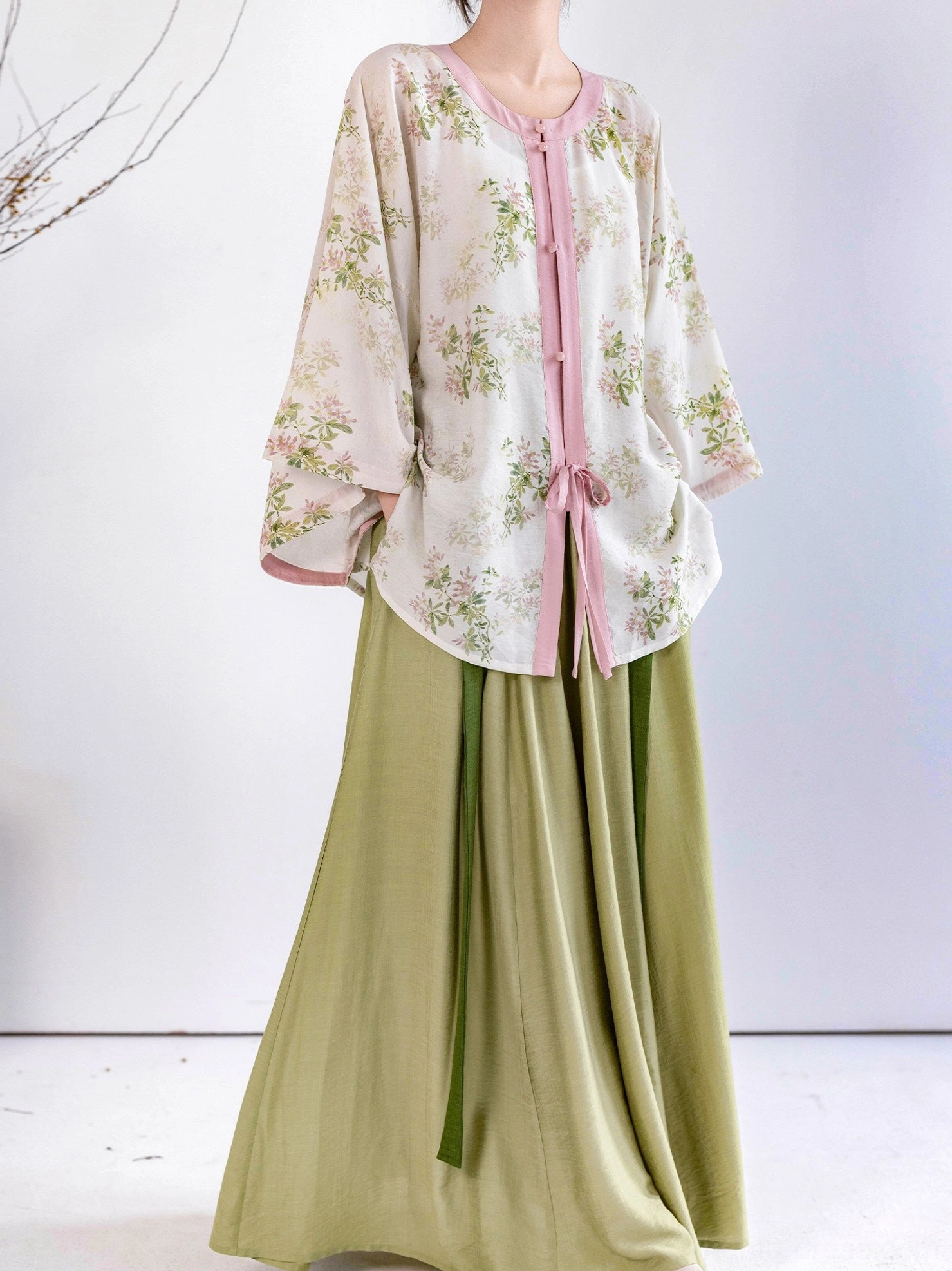 Full front view of Spring Branch Ming Dynasty Hanfu with ivory floral round collar top and sage green elastic waist skirt