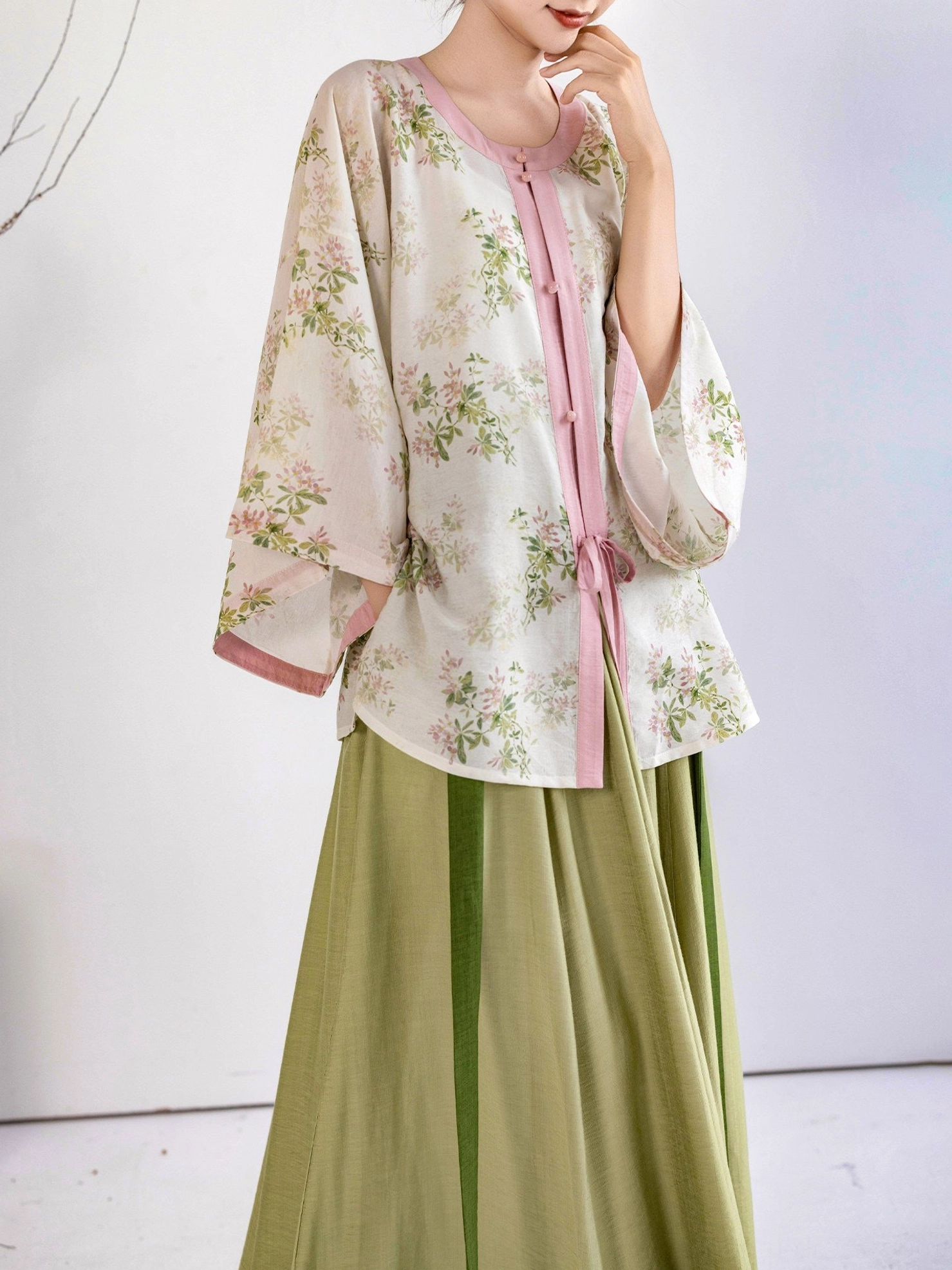 Side view of Spring Branch Ming Dynasty Hanfu outfit showing layered wide sleeves floral top and sage green long skirt