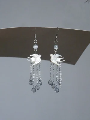Spring Equinox swallow tassel Chinese earrings with white shell bird charms, silver tone hooks, white beads and faceted grey drop pendants for Hanfu