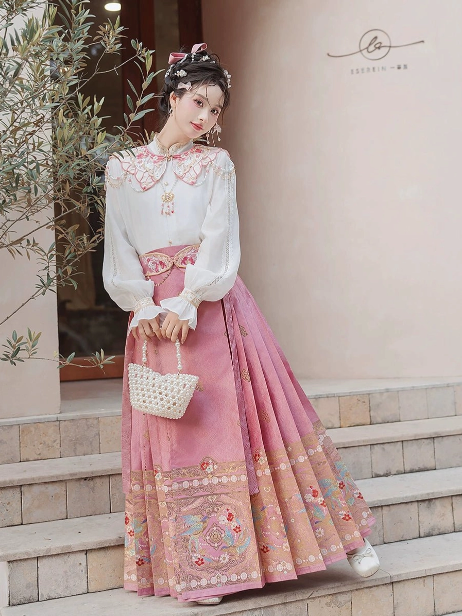 Outdoor view of Spring Melodies Ming Dynasty inspired Hanfu complete set with white blouse pink horse face skirt cloud collar and waist belt