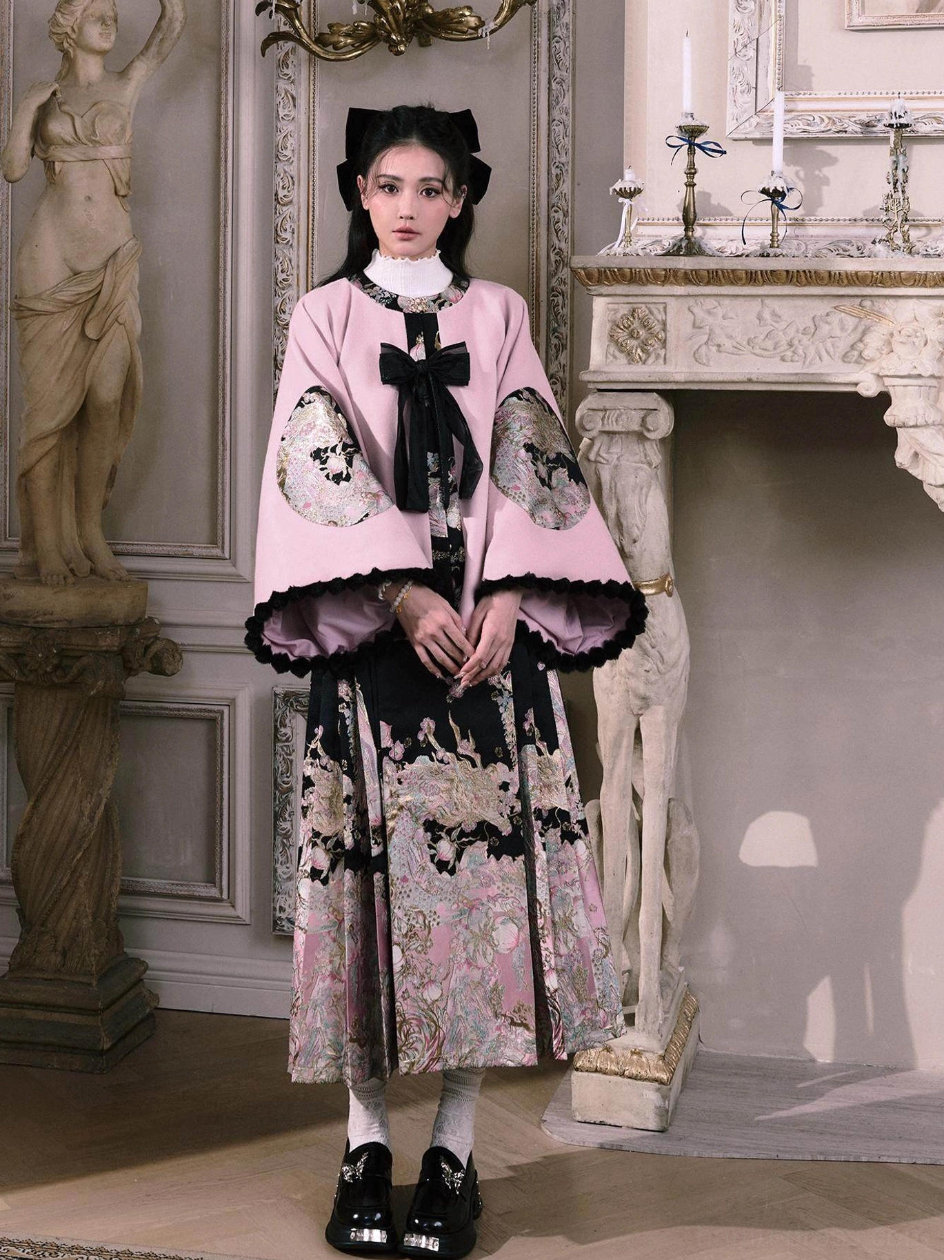 Spring Peach Mountain Hanfu two-piece outfit showing the decorative bow fastening embroidered sleeves and floral dragon skirt