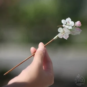 Handheld Spring Rain traditional Chinese hair stick showing pear blossom flower cluster and long hairpin stem