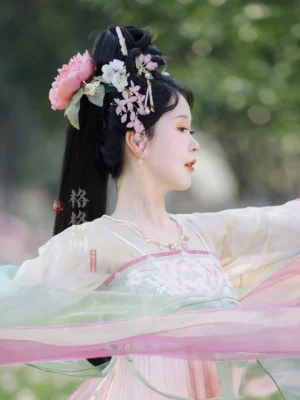 Classical Chinese Hanfu model wearing elegant wisteria glass hair pins in a traditional hairstyle outdoors with a soft green background