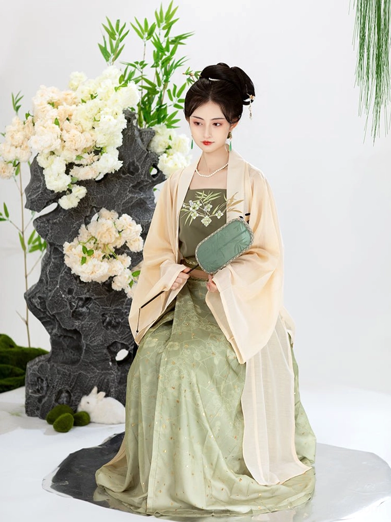 Side sitting view of a woman wearing an elegant three-piece Song Dynasty Qiyao Ruqun Hanfu outfit with coordinated green and cream colors