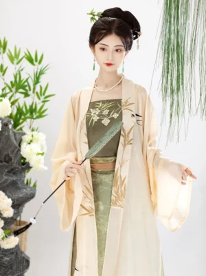 Upper-body view of Song Dynasty style Hanfu showing the moss green embroidered camisole, cream wide-sleeved Beizi and bamboo floral details
