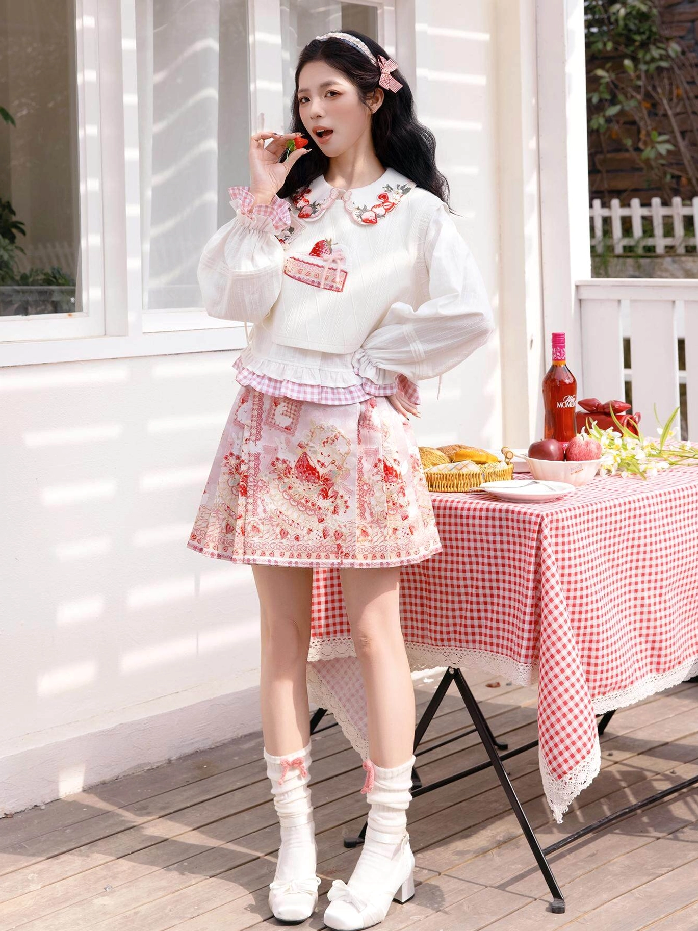 Full front view of strawberry cake modern Hanfu outfit with white cropped embroidered top and pink mini mamianqun horse face skirt at an outdoor picnic