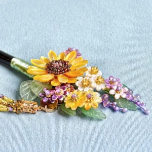 Close-up of sunflower floral decoration on Chinese hair stick featuring resin sunflowers, gemstone-look leaves, gold-tone details and pearl-style tassel beads