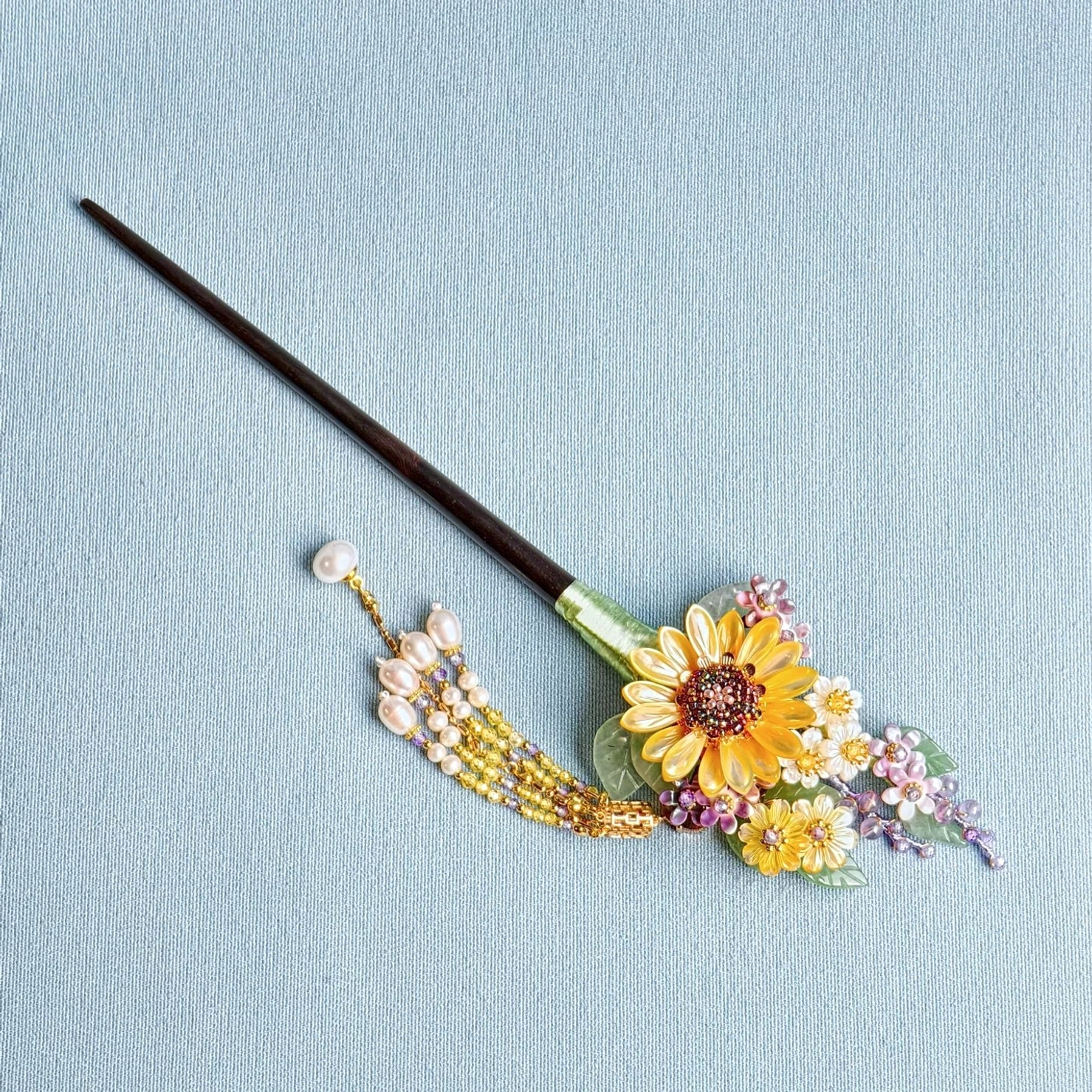 Full flat lay view of sunflower tassel Chinese hair stick with dark wooden pin, resin floral cluster, gold-tone beads and imitation pearls