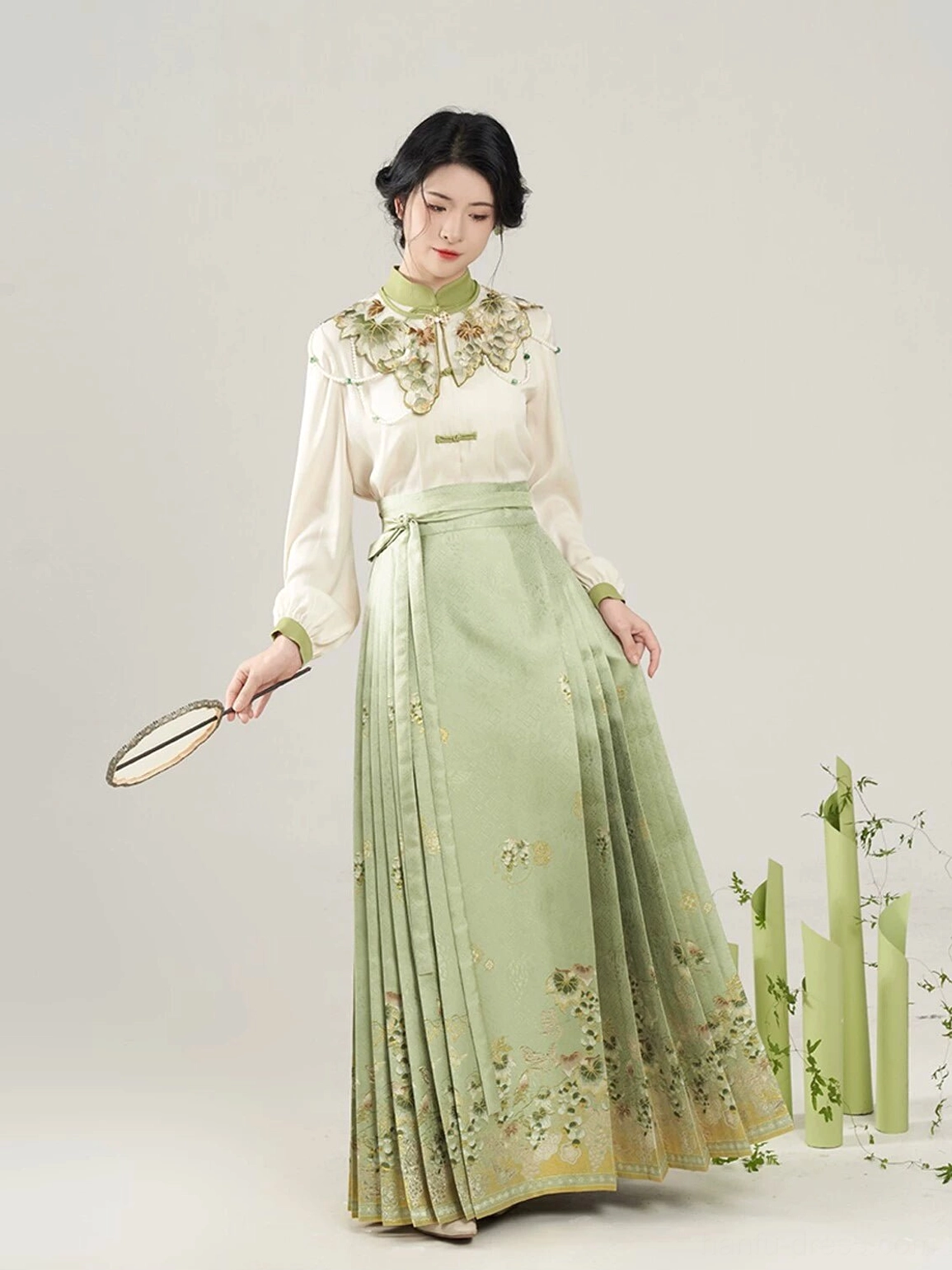 Side view of Sunshine Rose Hanfu outfit with frog button blouse pleated mamian skirt and floral brocade inspired details