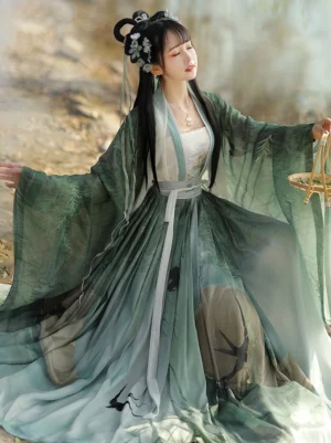 Green Swallow Flight Song Dynasty Qiyao Ruqun Hanfu complete set with gradient chiffon layers, flying swallow and Chinese landscape prints, wide sleeves, and matching waist sash worn beside misty willow water