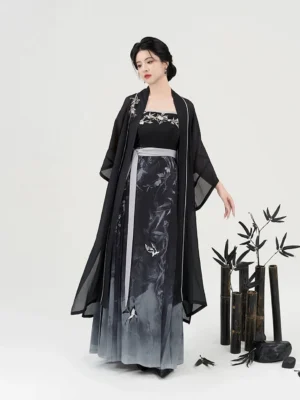 Swallow Returns ink wash modern Hanfu cardigan and slip dress full set front three quarter view with bamboo studio decor