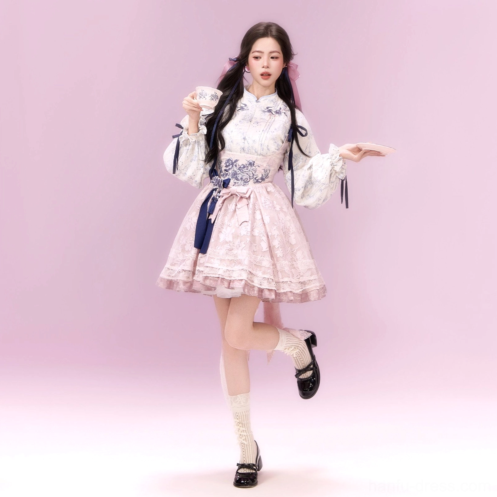 Sweet pink modern Hanfu xianxia Lolita dress set in a dynamic full-body pose with ruffled skirt, floral blouse, and decorative waist details