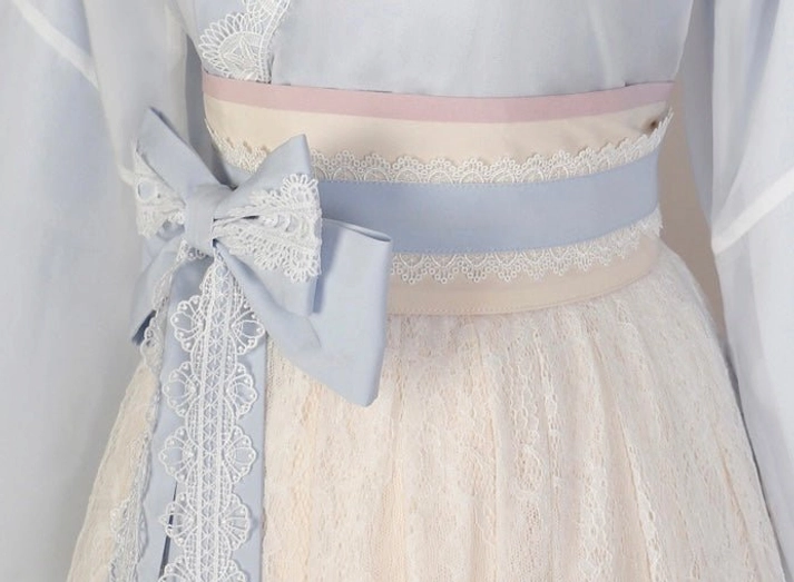 Close-up of layered lace waistbands and decorative bow sash details for sweetheart modern Hanfu dress in pastel colors