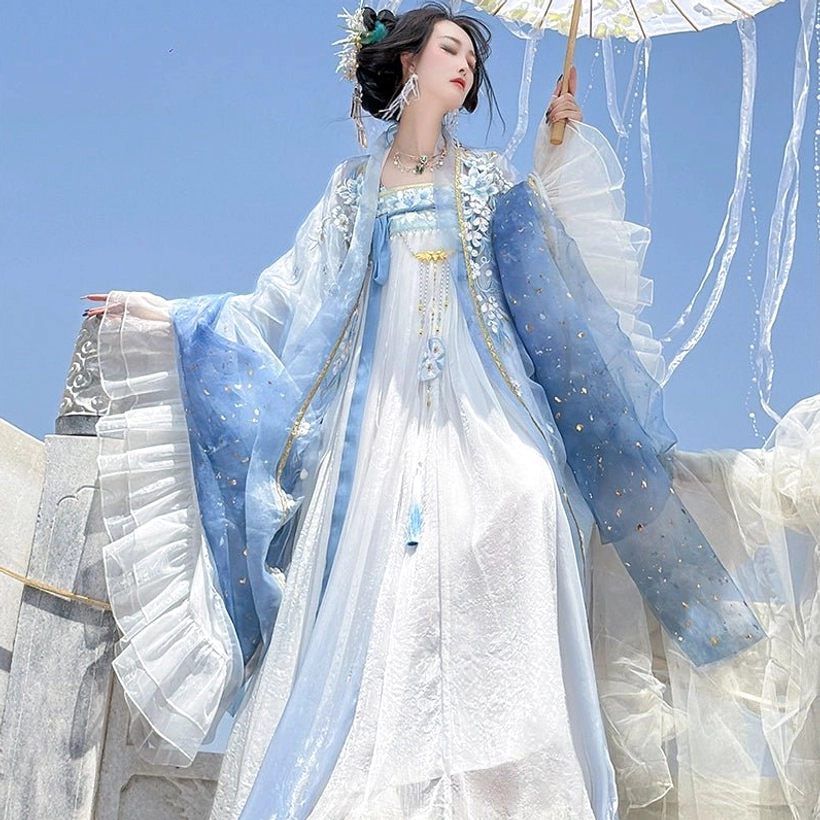 Close three-quarter view of Tang Dynasty inspired blue Qixiong Ruqun Hanfu with flowing sheer robe gold embroidery and umbrella