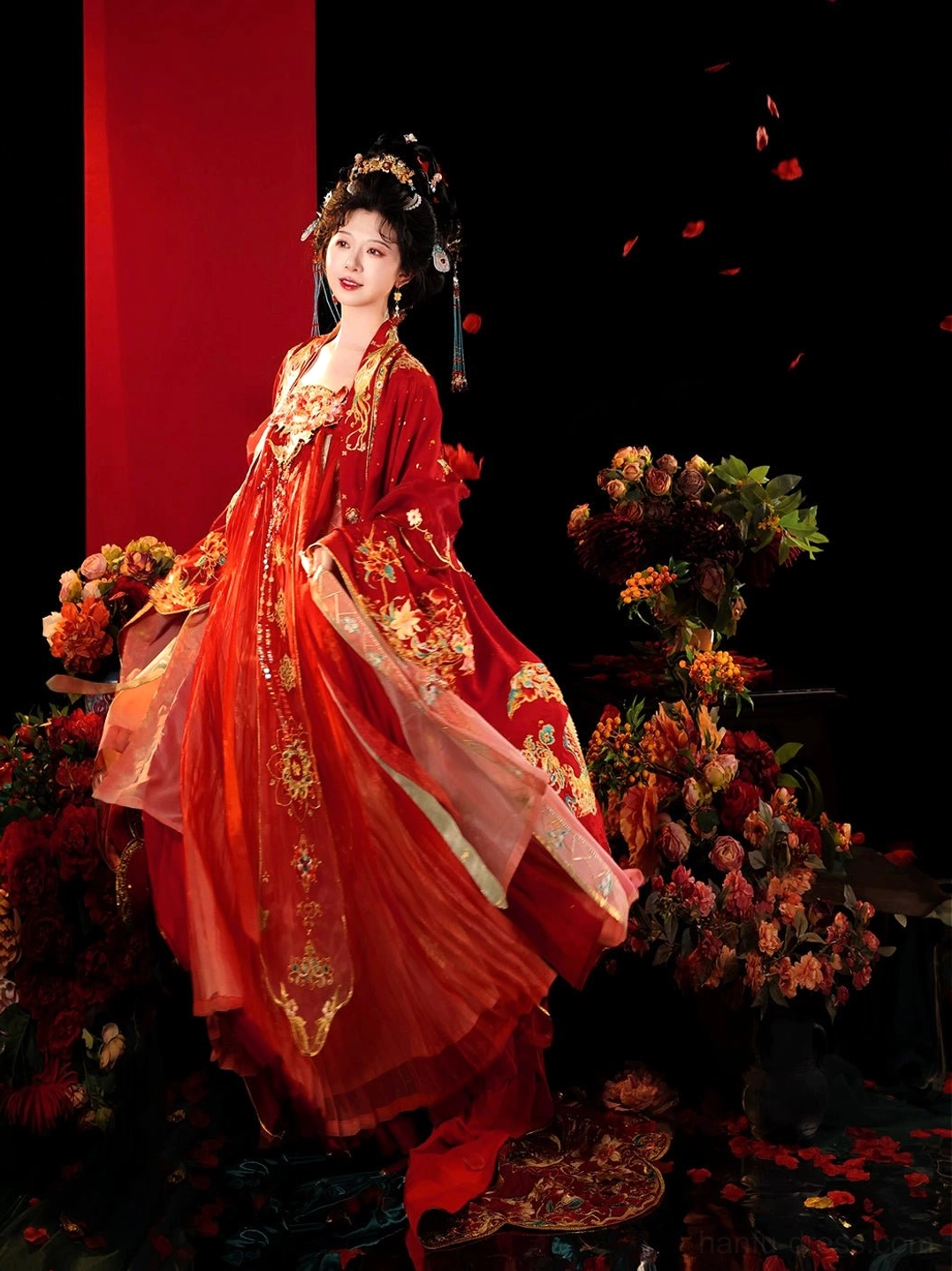 Side view of traditional Tang Dynasty bridal Hanfu with layered scarlet skirt, fitted bodice, golden floral embroidery, and dramatic ceremonial silhouette