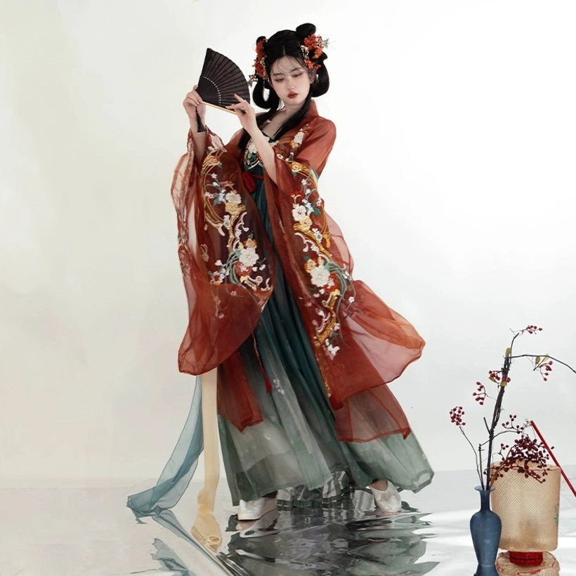 Full front view of a Tang Dynasty floral embroidered Heziqun Hanfu dress with rust red wide-sleeve coat, gradient teal skirt, red waist sash, and flowing translucent fabric