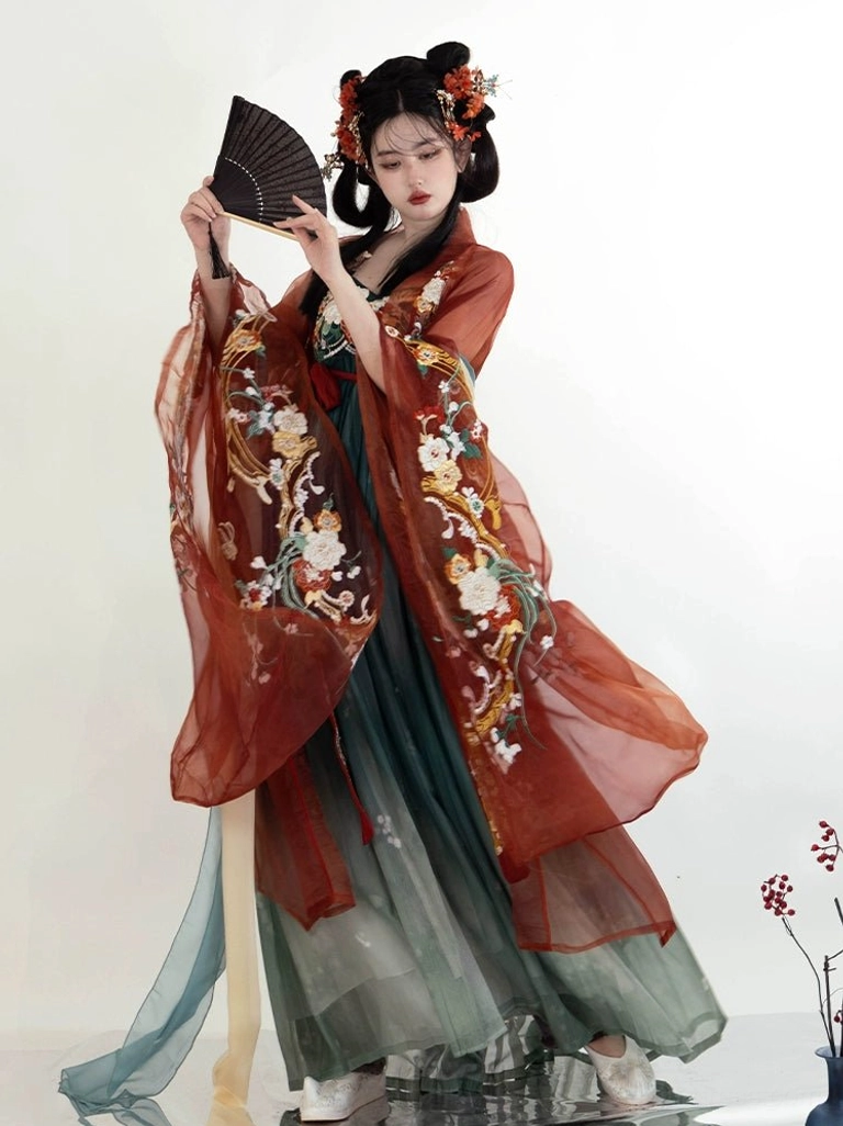 Front view of a Tang Dynasty Flower God Heziqun Hanfu dress with rust red sheer wide sleeves, floral embroidery, gradient teal pleated skirt, red sash, and traditional Chinese hair ornaments