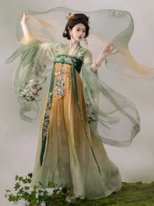 Front three-quarter view of green and yellow Tang Dynasty Qixiong Ruqun Hanfu dress with embroidered inner top, flowing sheer sleeves, and traditional styling